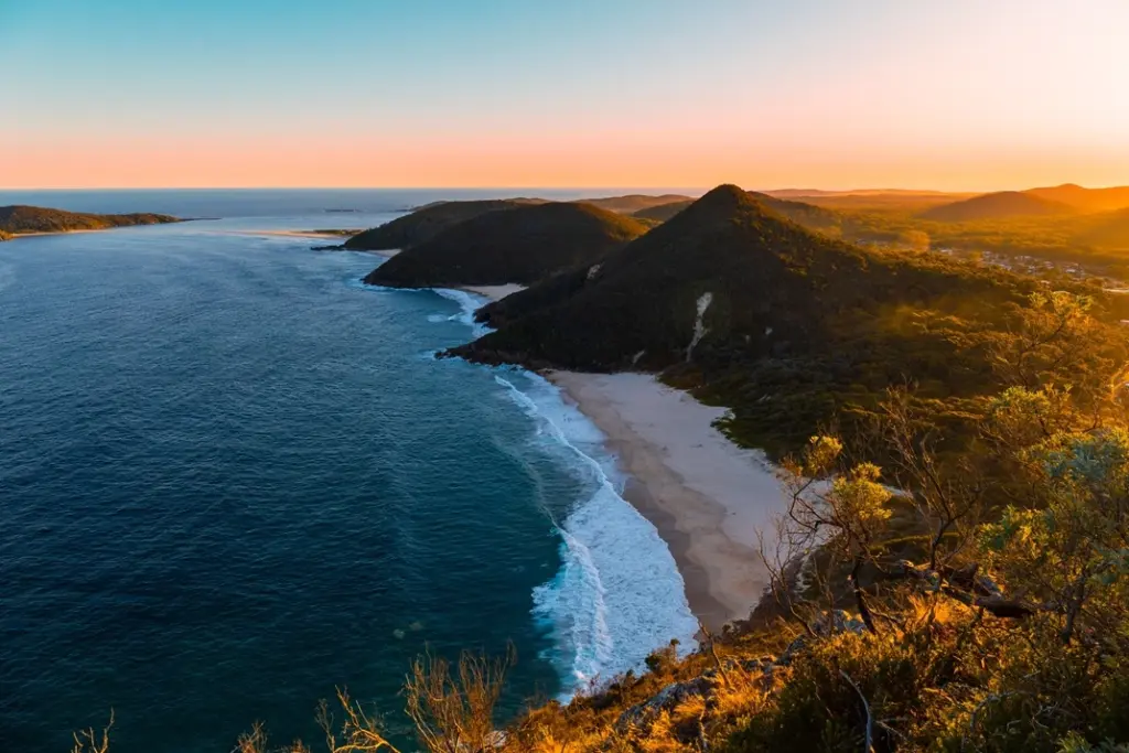Aerial view of Mt Tomaree and scenic coastline with beaches in Nelson Bay Port Stephens at sunset